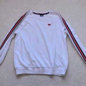 PINK crew neck with striped sleeves.